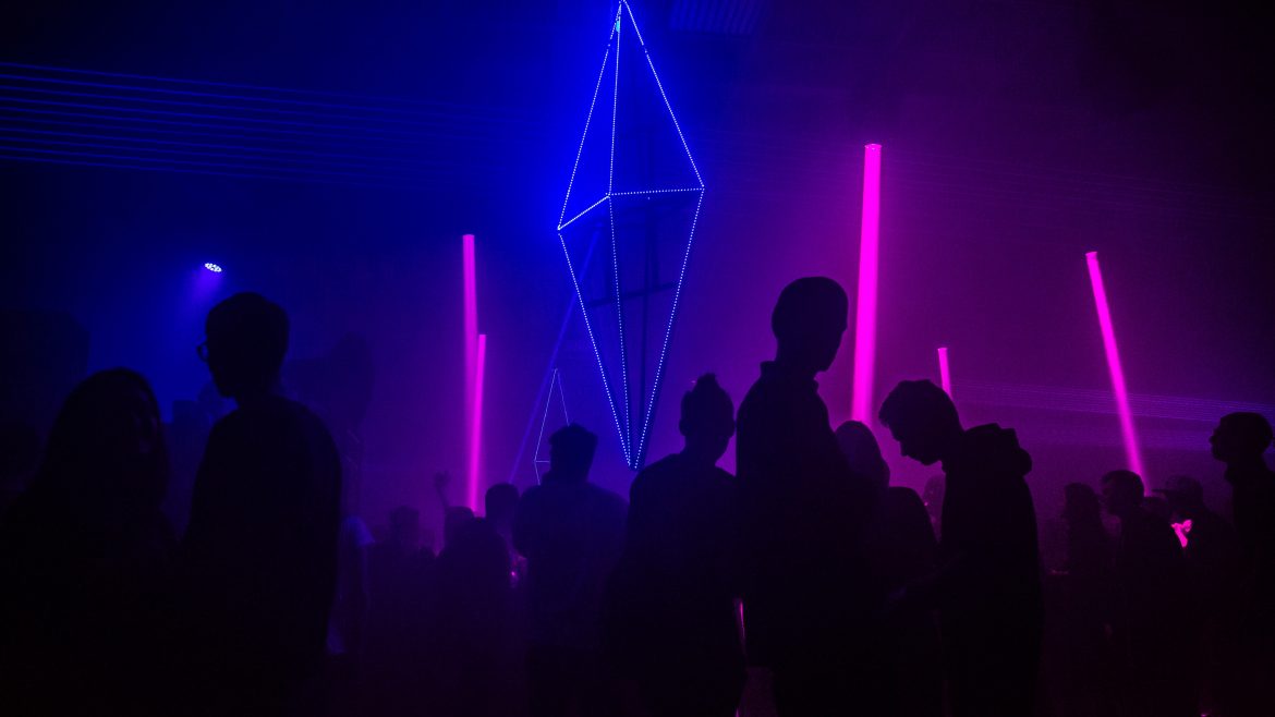 Clubbing industry's immersive technology inside a dimly lit club full of people