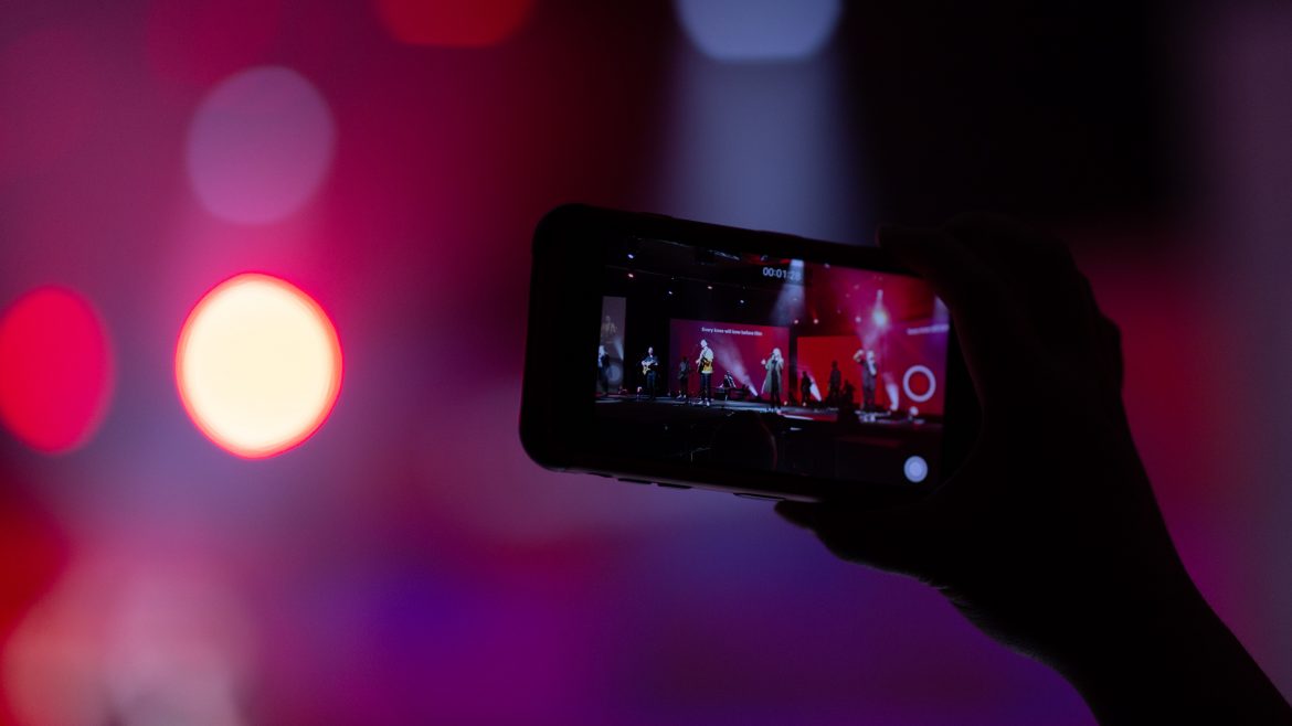 A mobile phone capturing the event