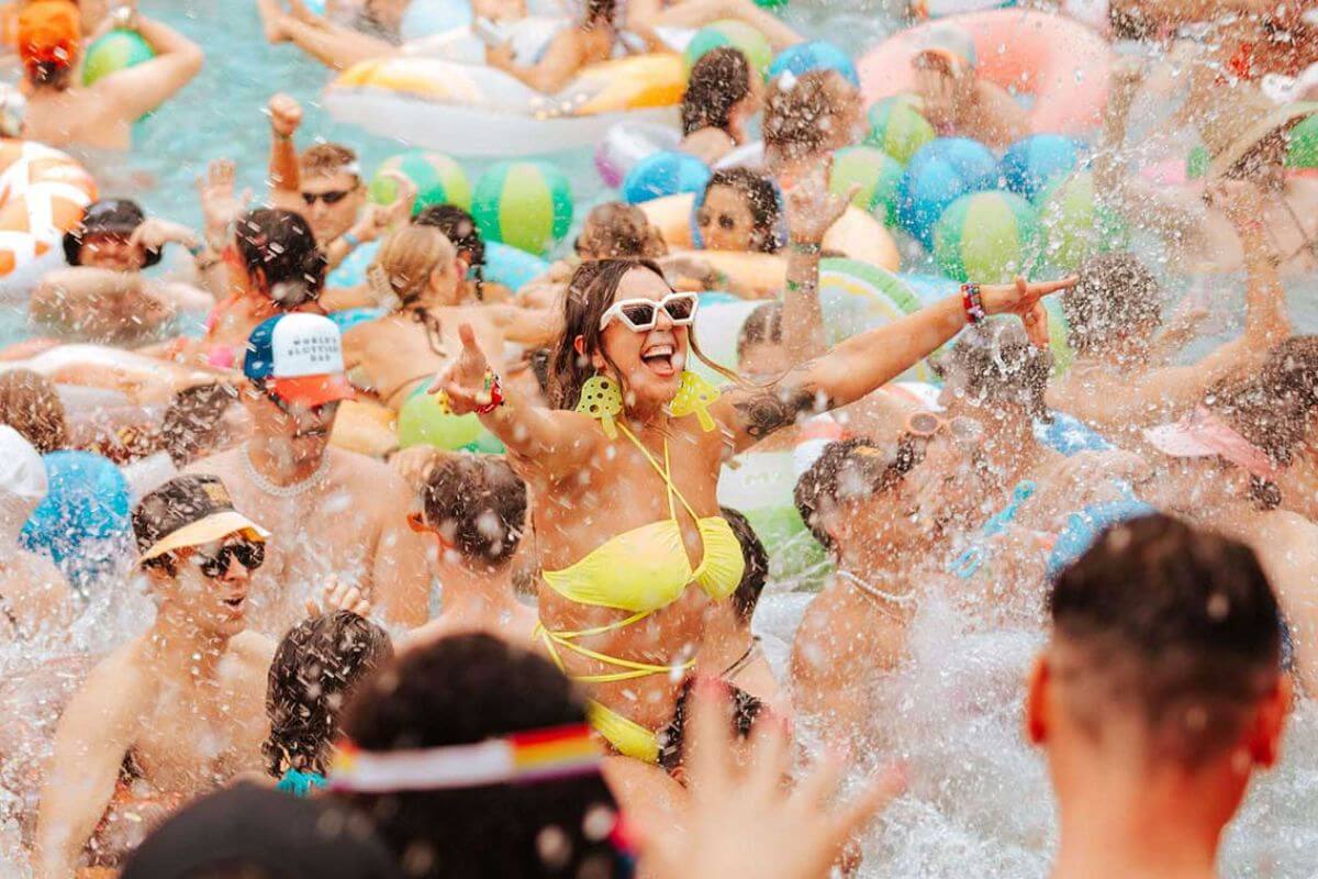 girl having fun at a pool party with splashing water