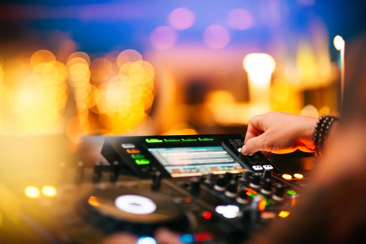 image of a club dj playing in a blurred crowd 